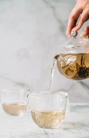 Two tea cups and a tea ot of white tea