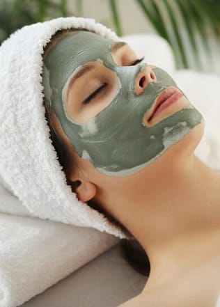 Woman relaxing while doing her natural face mask routine