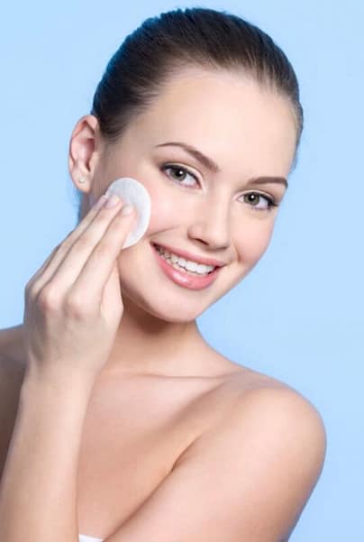 Woman applying her face toner 