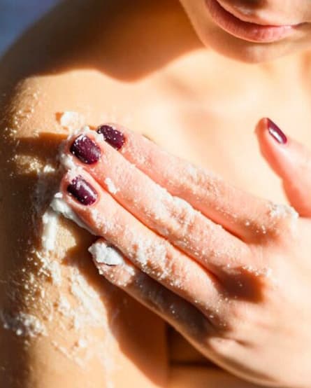 Woman doing skin scrubbing of her arm