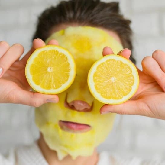 Woman with her lemon face mask