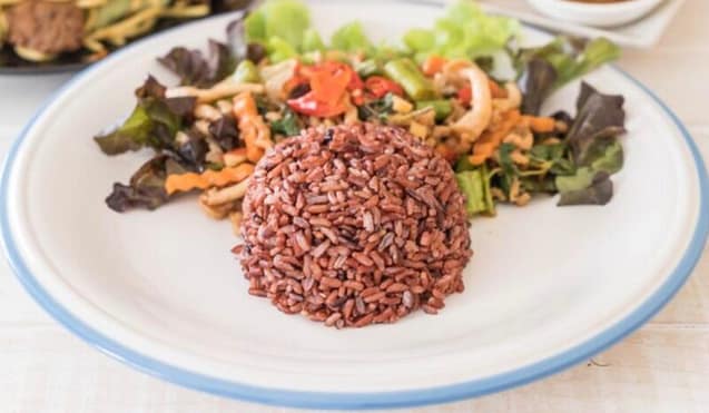A595A324-5974-4456-BE53-21BC79022C82 Delicious Red Rice with vegetables salad on a plate