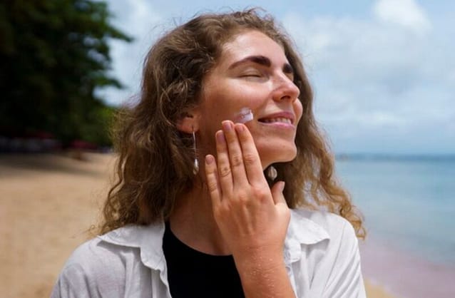 Woman enjoying walk under the sun but made sure she applied sunscreen 