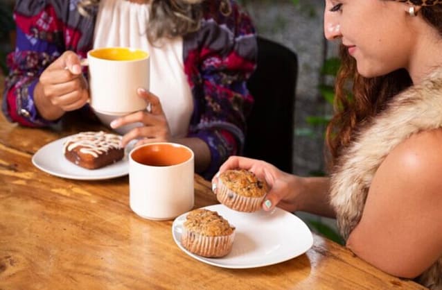 Two women enjoying their Tea with Pastries