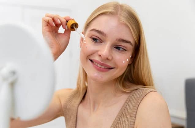 Woman applying a face cream