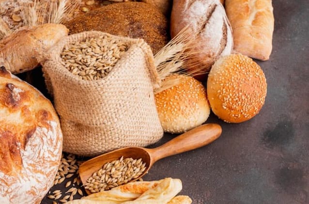 Sack of wheat beside some wheat breads