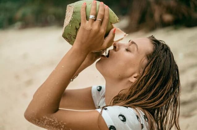 Woman drinking fresh coconut water