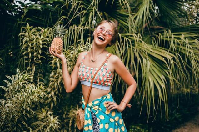 Happy woman enjoying her tropical fruit