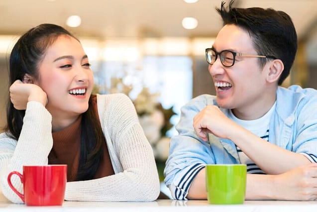 Young couple enjoying their tea while laughing