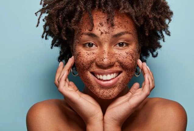 Woman doing skin scrubbing of her face