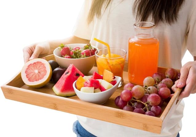 Healthy snack tray with different fruits and fruit drinks