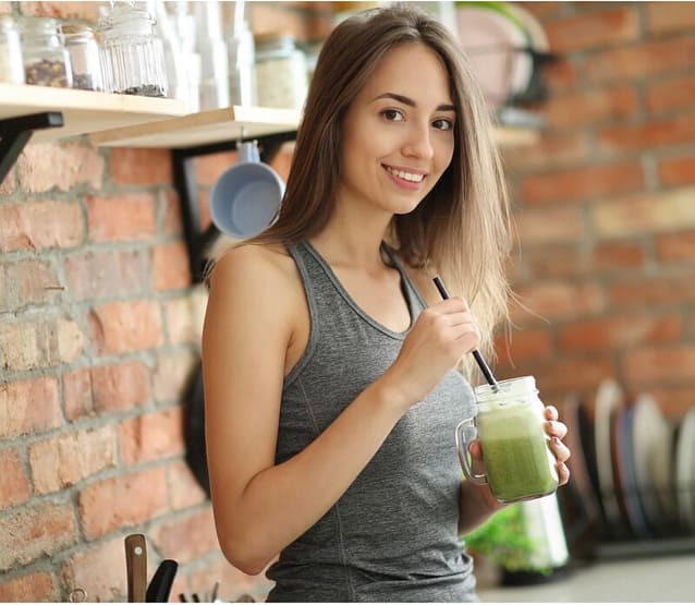 Woman with beautiful hair and skin holding a smoothie