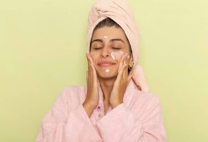 2C22B163-D217-4926-8BEF-0831756B39BA Woman applying face moisturizer