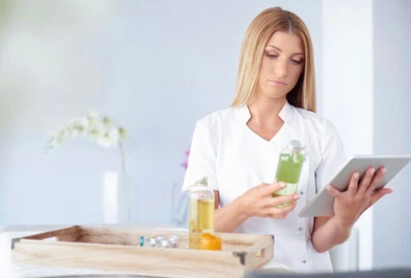 Woman showing one of the ways How to Detect Greenwashing in Personal Care Products and that is inspecting the label of the product.