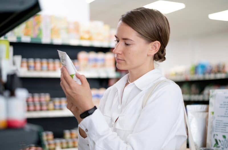 Woman reading product label