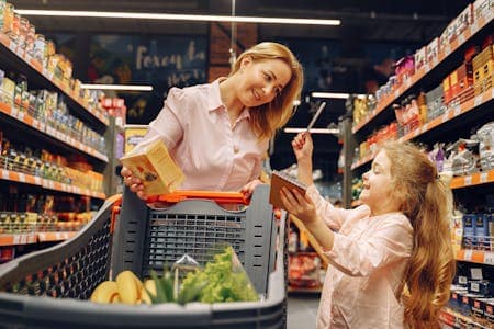 Mother and daughter buying food from the supermarket