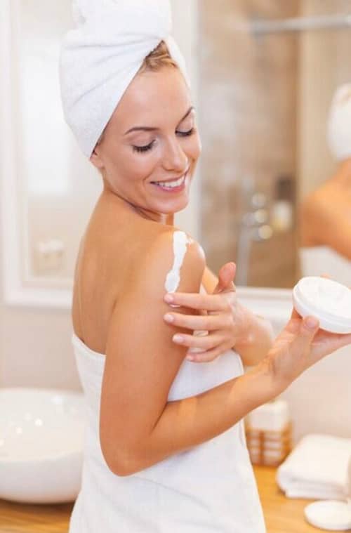 45B84B46-22F1-4315-8C88-D4A30B92D53D Smiling woman enjoying her application of organic body lotion